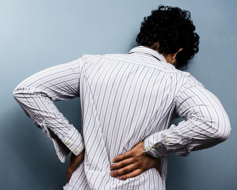 Symptoms of compressed nerves may include tingling and numbness in the back.