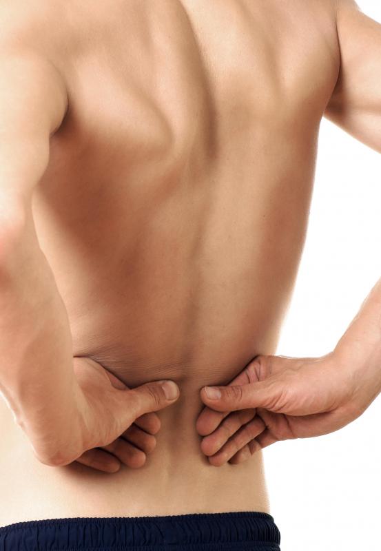 Man reaching back and pressing on the location of his kidneys.