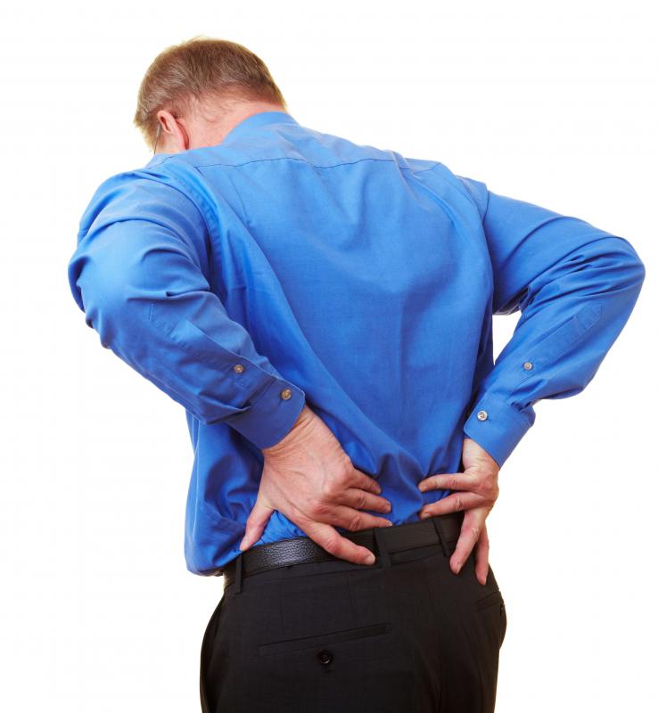 Man experiencing lower back pain from a bulging disk.