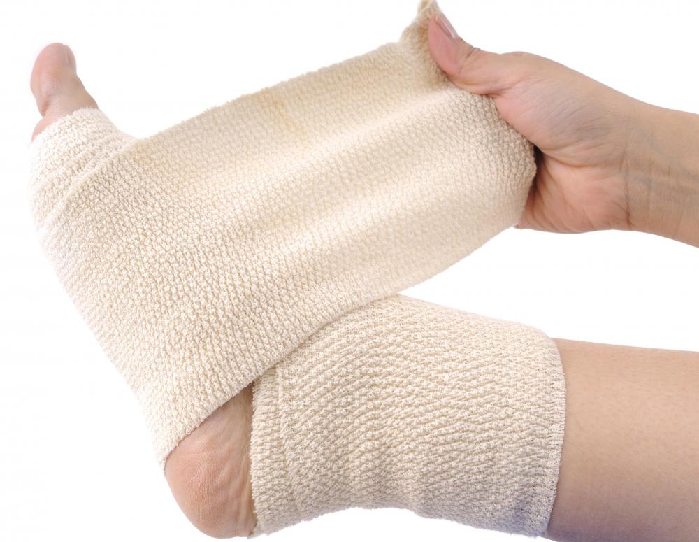 A bruised ankle should be wrapped in a medical bandage and kept elevated.