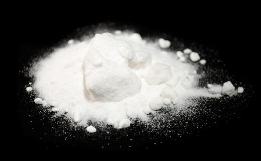 Home remedies involving baking soda as an antacid recommend dissolving one-half teaspoon of baking soda into one-half cup of water.