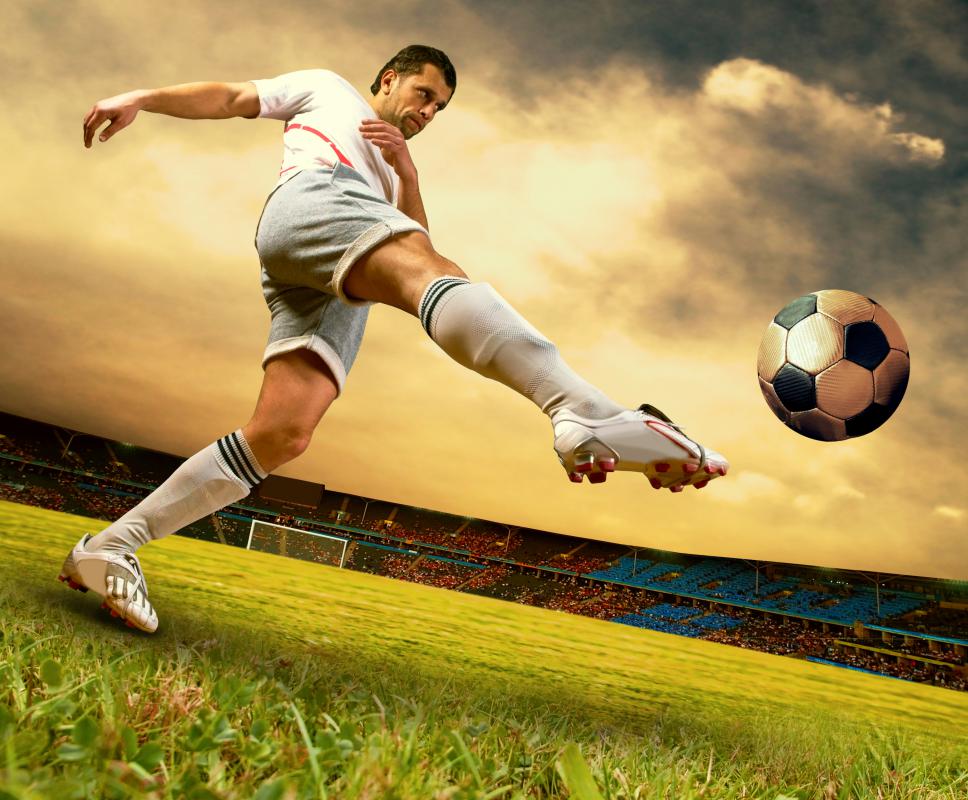 A soccer player wearing cleats, a common type of athletic apparel.