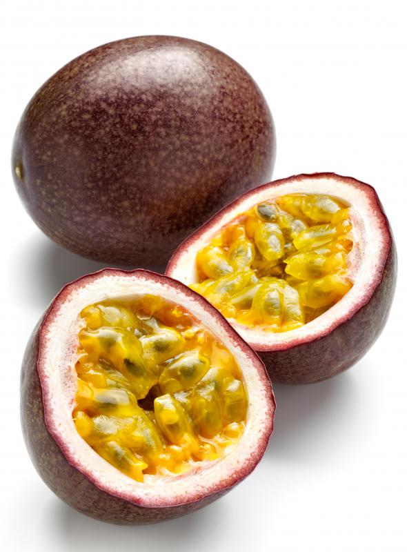 Whole and cut passion fruit, the fruit of a passion flower.