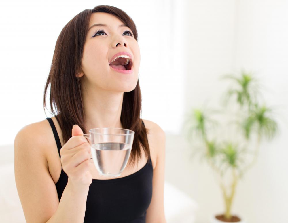Gargling with warm salt water may help soothe a sore throat.