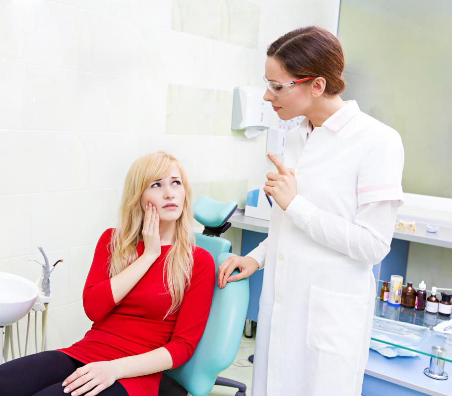 Dentists will inject local anesthesia into a patient's gum tissue before performing a molar extraction.