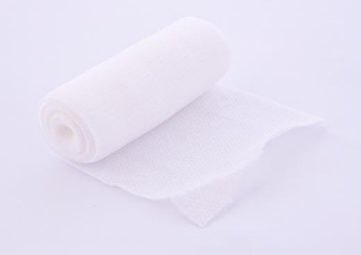 Roll of gauze bandage material.