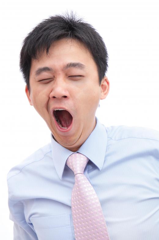 A man yawning to pop his ears.