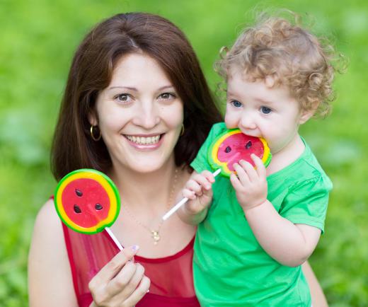 Parents can use continuous reinforcement in the form of candy or attention to teach their child desired behaviors before switching to a partial reinforcement system as the child gets older.