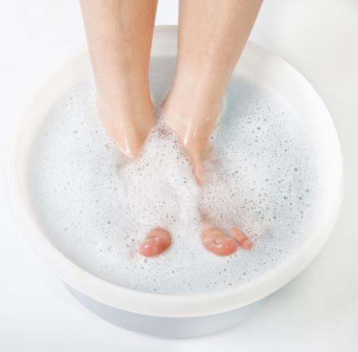 A person having a foot bath with vinegar in it.