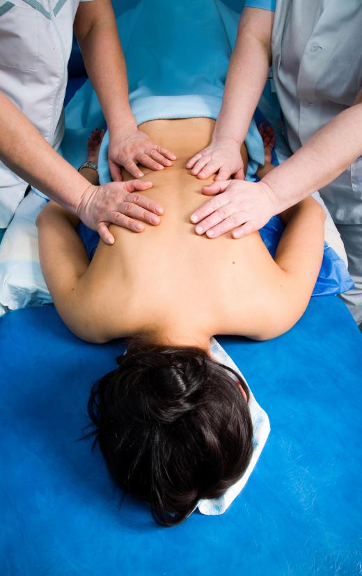 One therapist might work one area of the body while another works another area in a four hand massage.