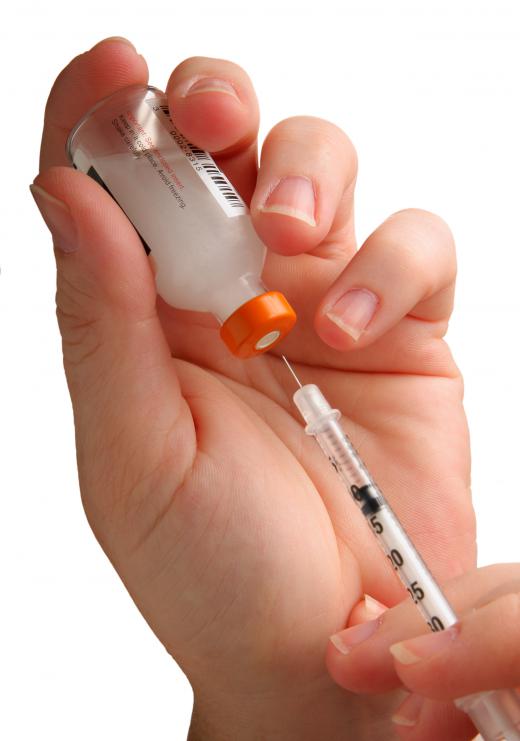 A person filling a syringe.