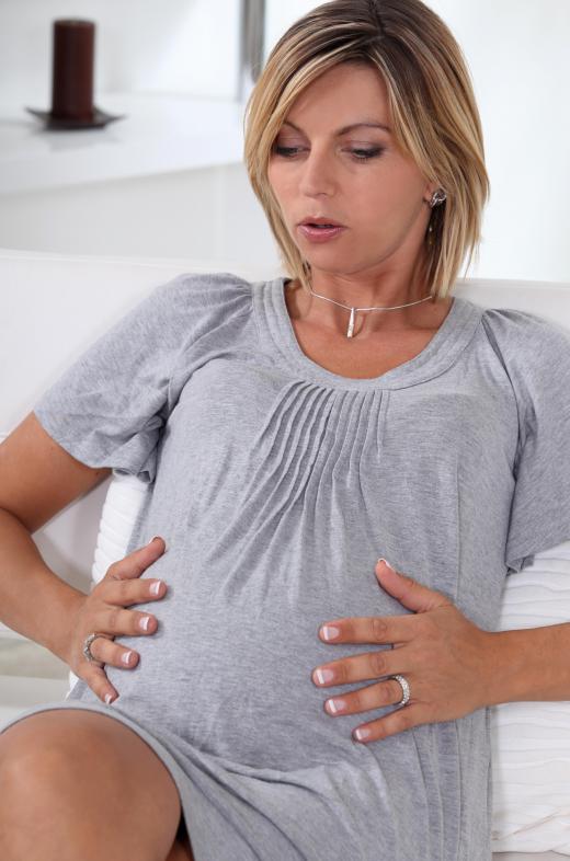 A pregnant mother can massage her belly or gently push back when the baby moves in utero to help bond with the child.