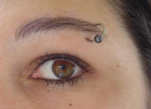 A swollen eyebrow may be caused by a new or infected eyebrow piercing.